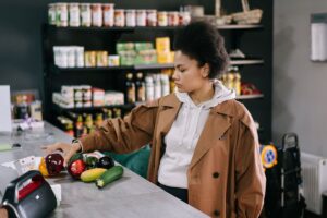 野菜を手に取って買い物をする女性